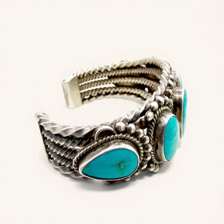 Silver and turquoise bracelet on a white background