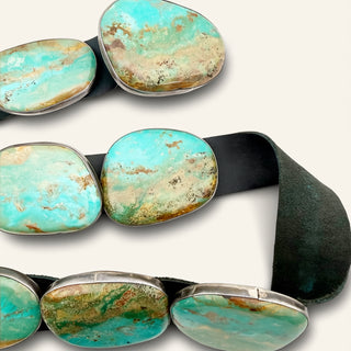 Turquoise stone belt buckle on a white background