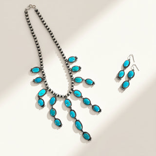 Turquoise jewelry set on a beige background