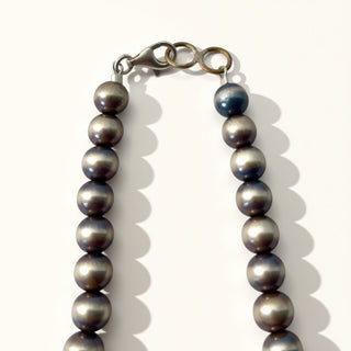 Pearl with a clasp on a white background