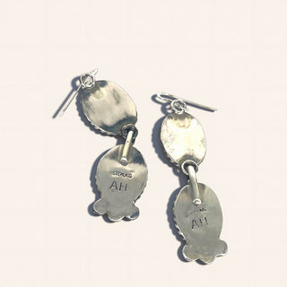 Silver  earrings with 'SILVER' and 'AH' markings on a white background