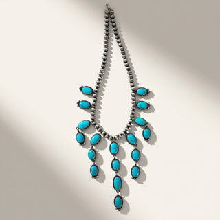 Necklace with turquoise stones on a beige background
