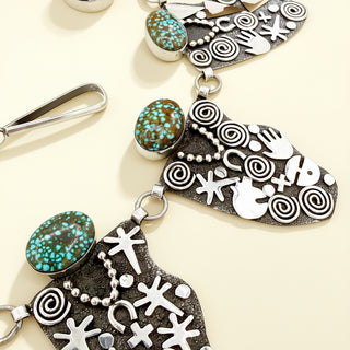 Silver and turquoise necklace on a beige background