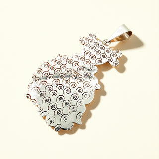 Silver stamp pendant on a beige background