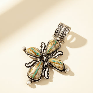 Brown cross pendant on a beige background