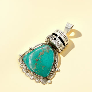 Green warrior pendant on a beige background