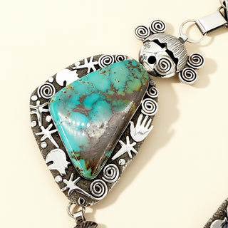 Turquoise maiden pendant on a beige background