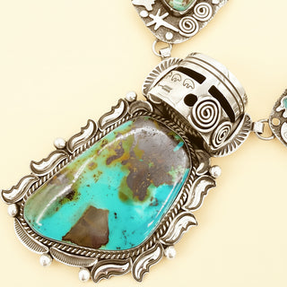 Turquoise warrior necklace on a beige background