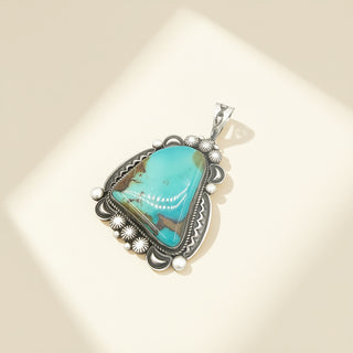 Turquoise pendant on a beige background