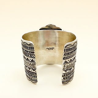 Silver cuff on a beige background