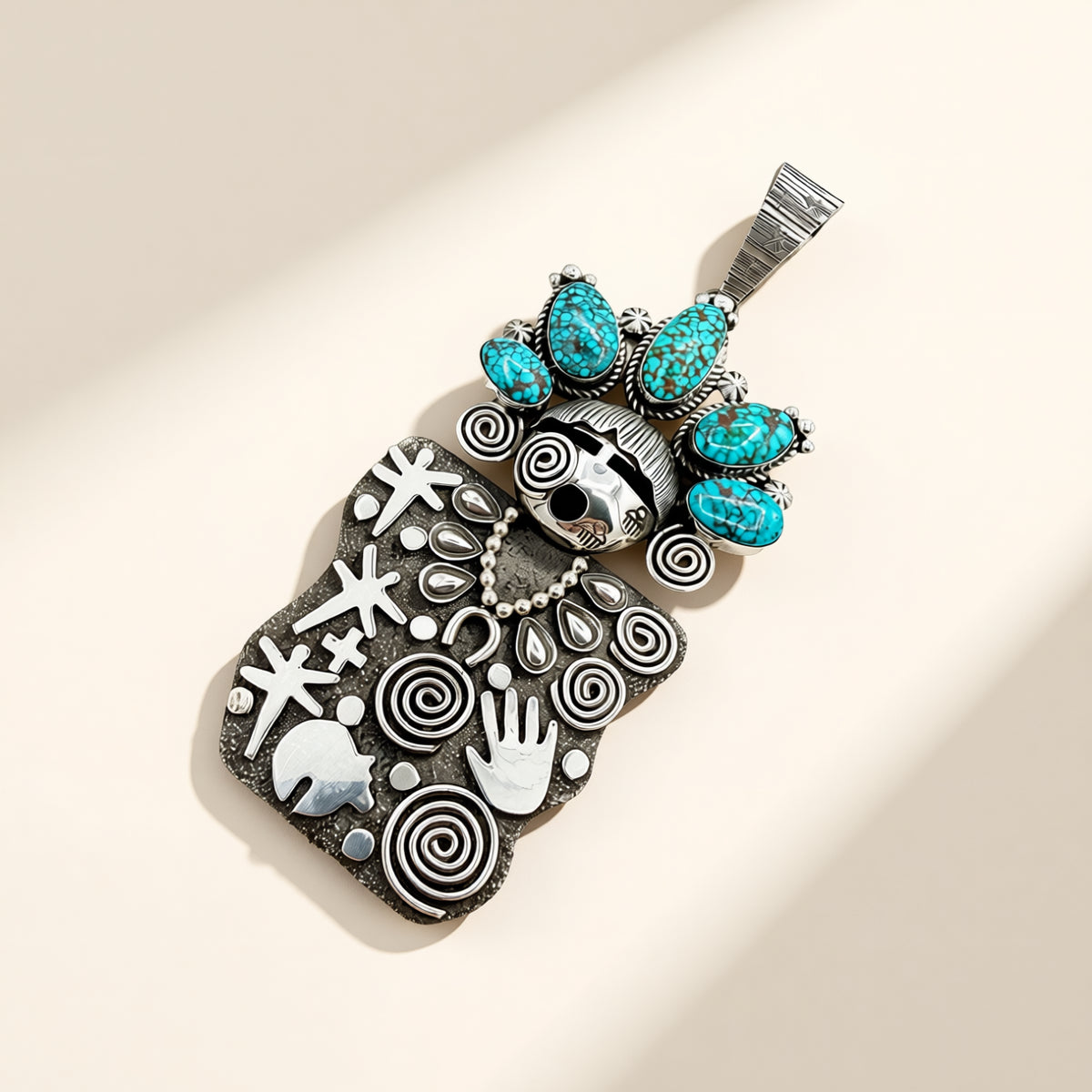 Decorative pendant with turquoise stones and intricate patterns on a beige background