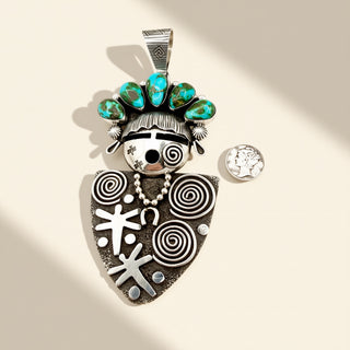 Decorative pendant with turquoise stones and spiral patterns on a beige background