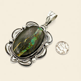 Silver pendant with an oval stone on a beige background
