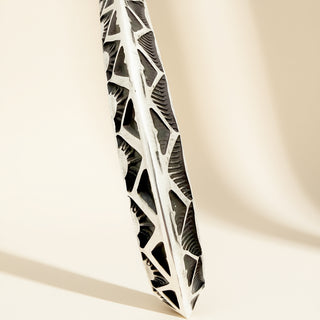 Decorative silver cuff  on a beige background