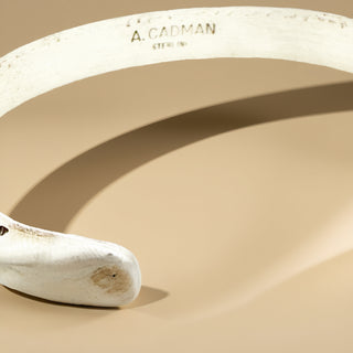 Silver cuff on a beige background