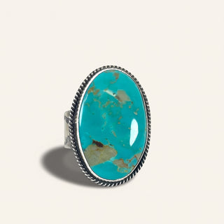Turquoise ring with silver band on a white background