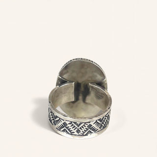 Silver ring with geometric pattern on a white background