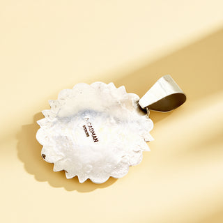 Silver pendant stamp on a beige background