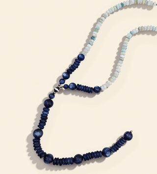 Blue necklace on a beige background