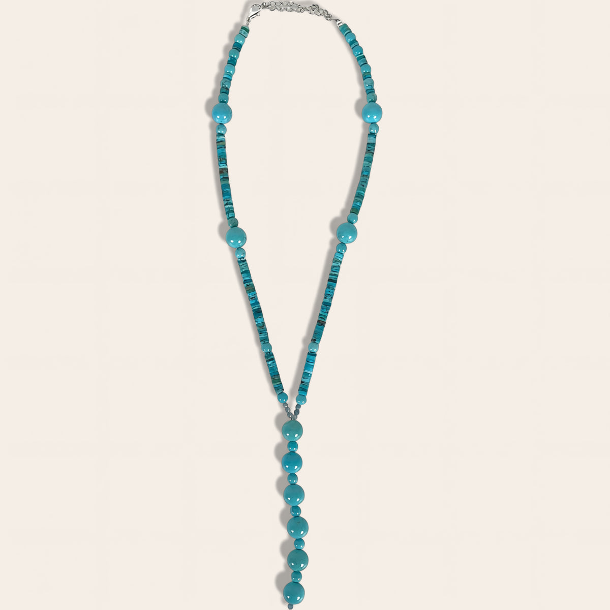 Turquoise beaded necklace on a light gray background