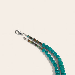 Beaded necklace  with turquoise beads on a beige background