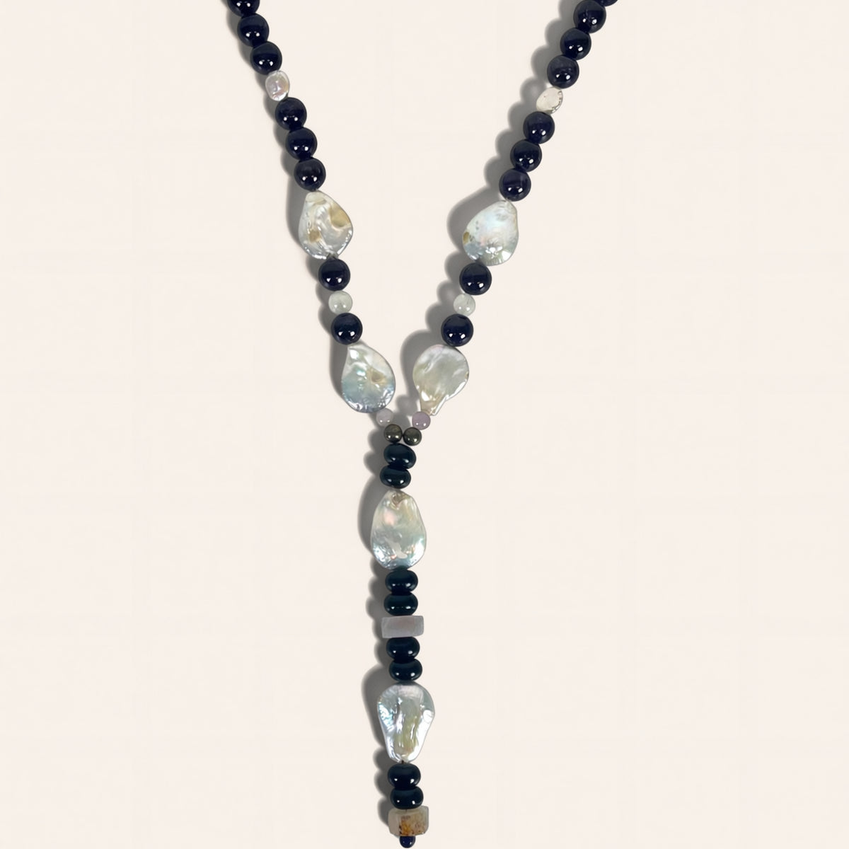 Necklace with black and white beads on a light background