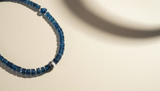 Blue necklace on a beige background