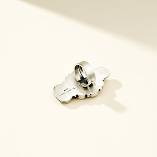 Silver ring shank with stamp on a beige background