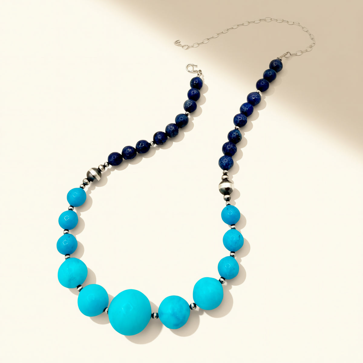 Necklace with blue and turquoise beads on a white background