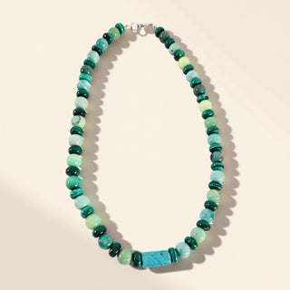 green beaded necklace on a beige background