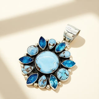 Jewelry pendant with blue stones on a beige background