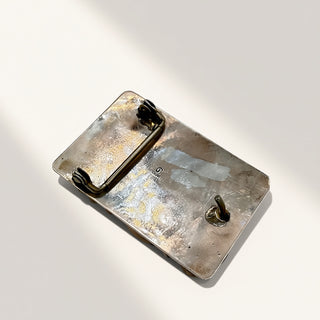Metallic pouch with textured surface on a white background