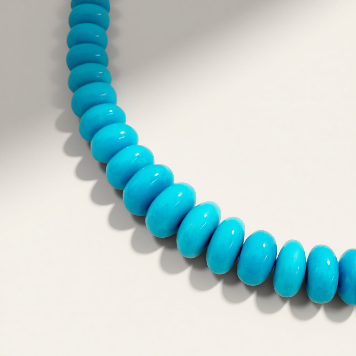 Blue beaded necklace on a white background