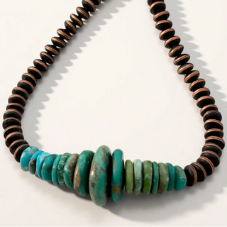 Necklace with brown and turquoise beads on a white background