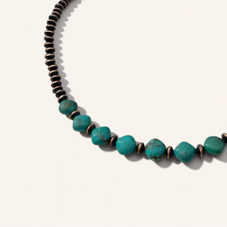 Necklace with black and turquoise beads on a white background