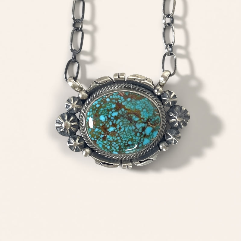 Turquoise pendant necklace on a white background