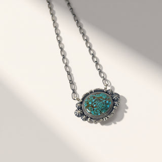 Necklace with a turquoise pendant on a white background