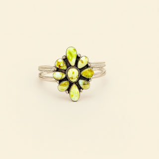 Silver ring with yellow stone on a beige background