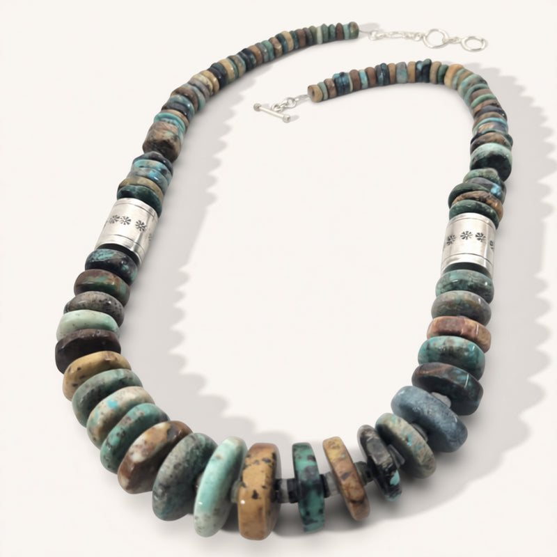 Necklace with multicolored beads and silver accents on a white background