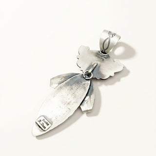Silver pendant with leaf design on a white background