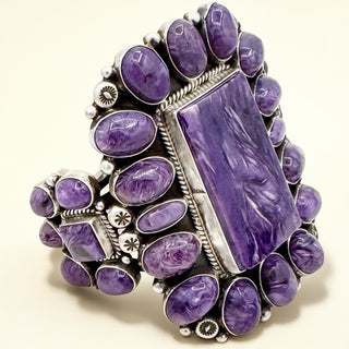 Purple stone cuff with silver accents on a beige background