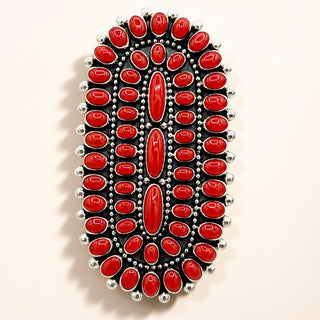 Ring  with red stones and silver accents on a white background