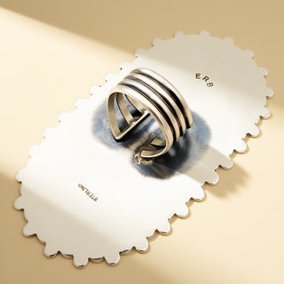 Ring on a decorative white base with 'ERB' branding.