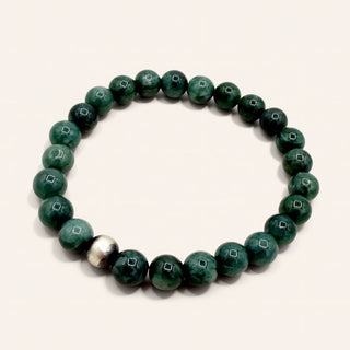 Green beaded bracelet on a white background
