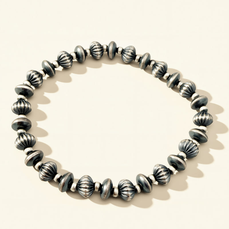 Silver beaded bracelet on a light background