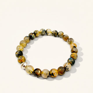 Beaded bracelet with yellow and black beads on a white background