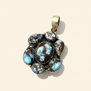 Turquoise stone pendant on a beige background