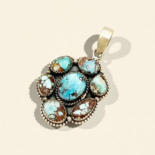 Turquoise stone pendant on a beige background