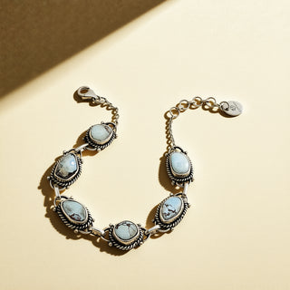 Silver bracelet with blue stones on a beige background
