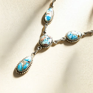 Turquoise stone necklace on a beige background